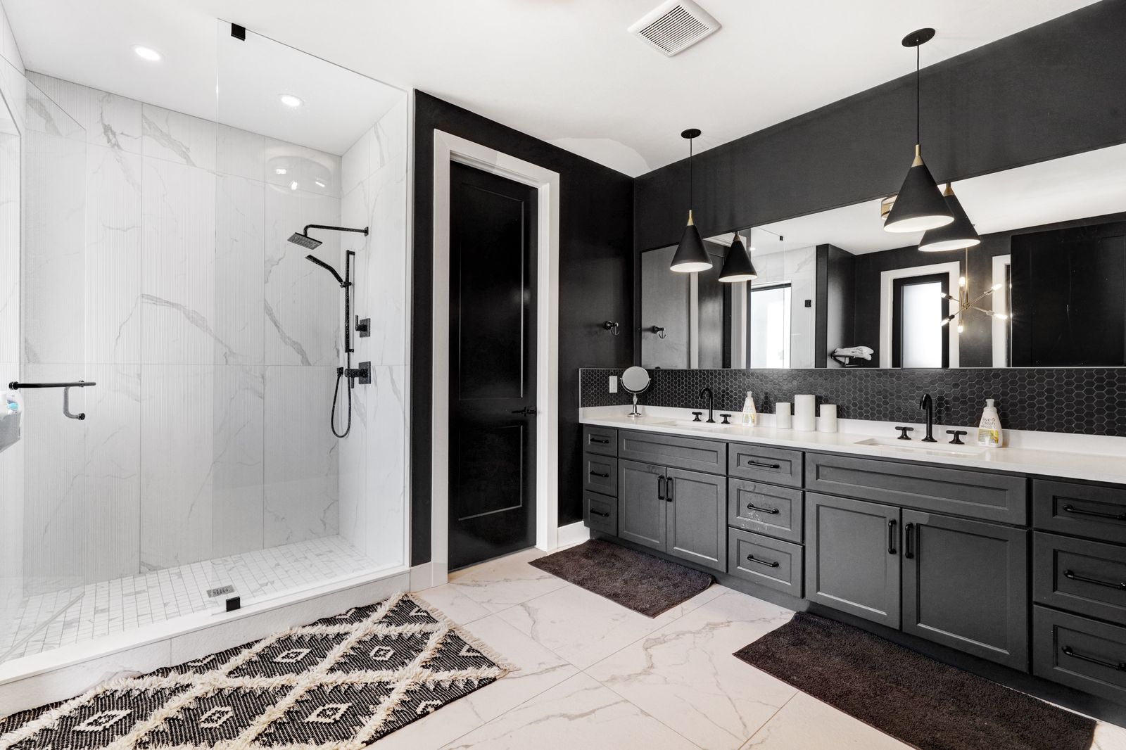 Ensuite with matte-black double vanity in a completed Carnaby home